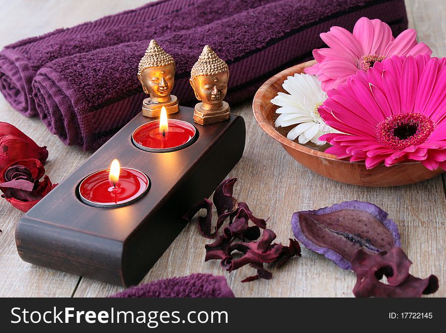 Towels candles and flowers in a spa area. Towels candles and flowers in a spa area