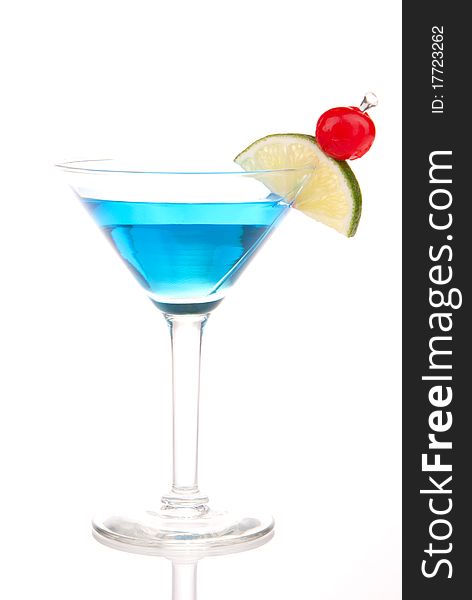 Blue Martini cocktail with gin, vodka, blue curacao, pineapple juice, pink grapefruit juice, lime and classic red cherry isolated on a white background