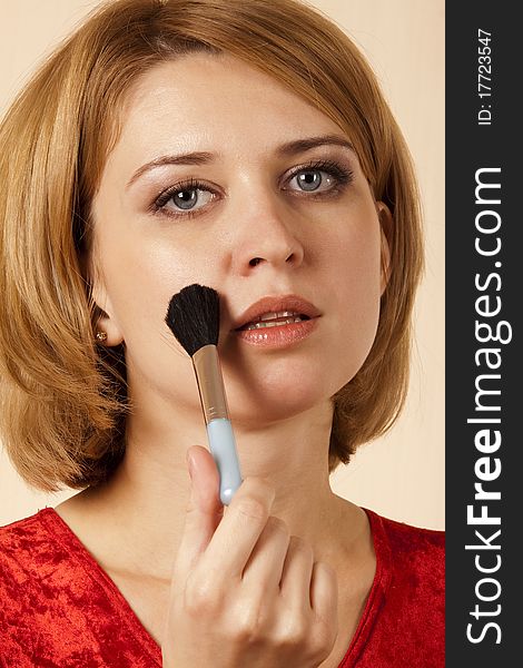 Portrait of the girl with a brush for make-up