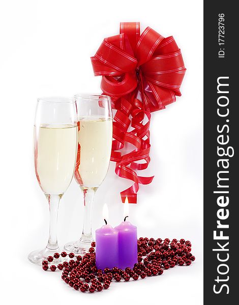 Two glasses of champagne, red ribbon and red beads. Two glasses of champagne, red ribbon and red beads