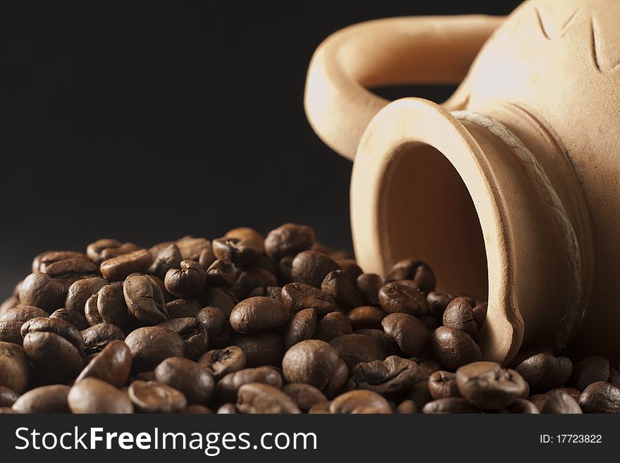 Macro picture of coffee beans and container isolated on black