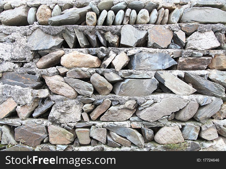 Hard rock wall, mountain village house wall.