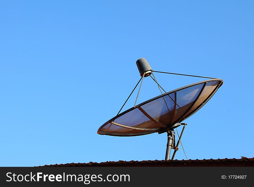 Satellite on a roof on in the morning