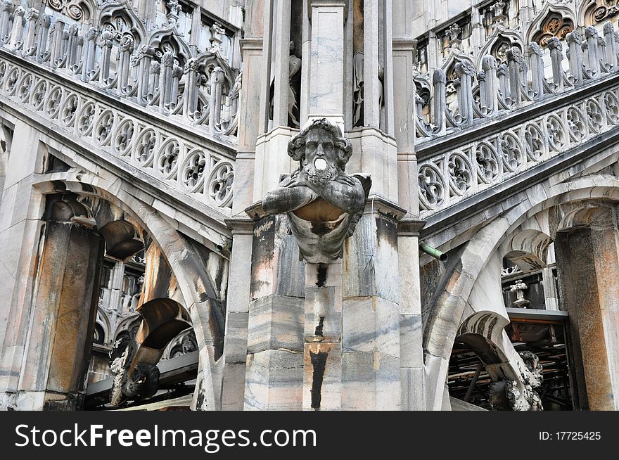 Gothic architecture with gargoyle in central perspective at Milan's Duomo in Italy. Gothic architecture with gargoyle in central perspective at Milan's Duomo in Italy