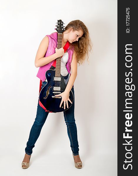 Young girl with a guitar on a white background