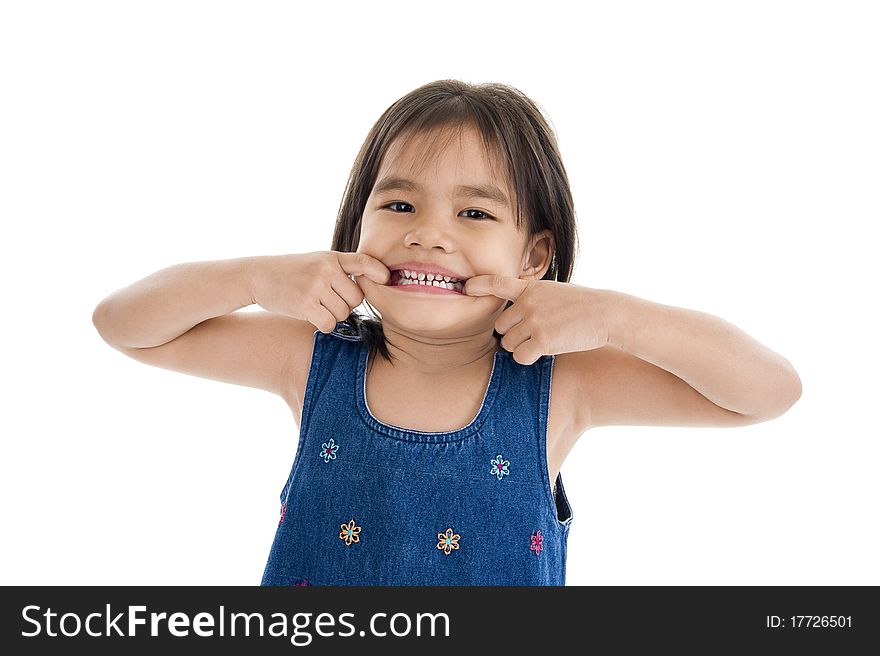 Cute little girl making a grimace, isolated on white background. Cute little girl making a grimace, isolated on white background