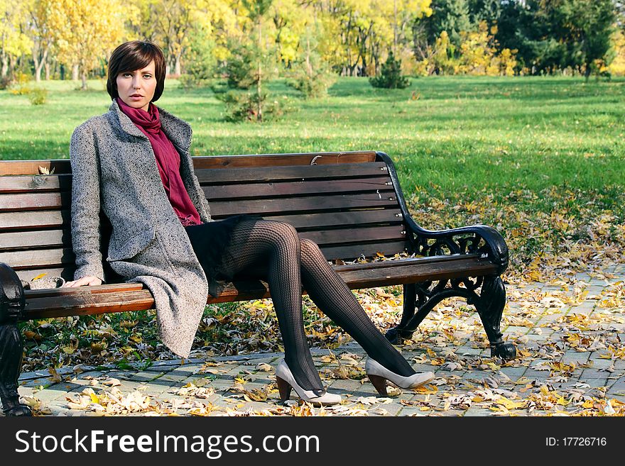 The girl in the park on a bench in nature