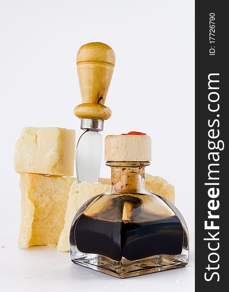 Balsamic vinegar and parmesan with knife isolated white background. Balsamic vinegar and parmesan with knife isolated white background