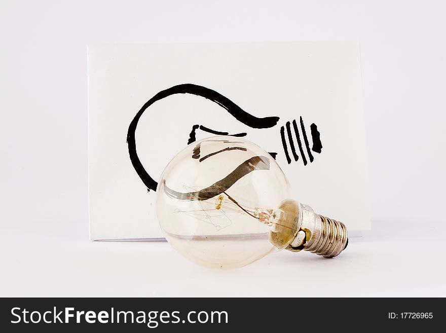 Real light bulb and illustration light bulb in paper with white background. Real light bulb and illustration light bulb in paper with white background