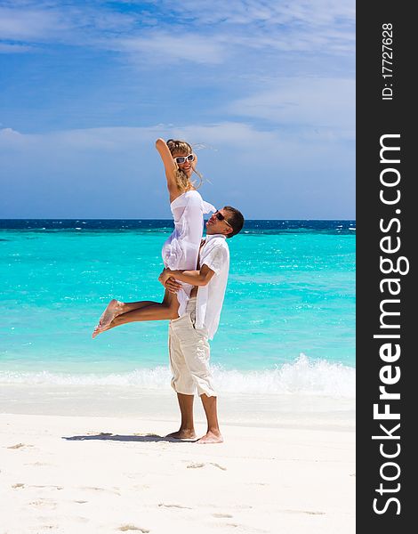 Happy Young Couple On A Beach