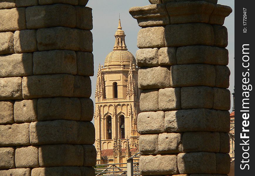 View of the cathedral through the arches of the aqueduct in segovia in spain. View of the cathedral through the arches of the aqueduct in segovia in spain