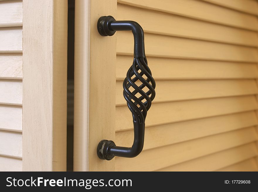 Forge door handle mounted on a mediterranean style shutter