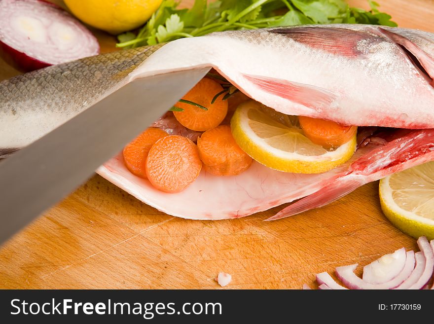 Photo of sea bass on a wood chopping board