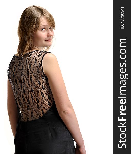 Blonde in black dress looks back on a white background. Blonde in black dress looks back on a white background