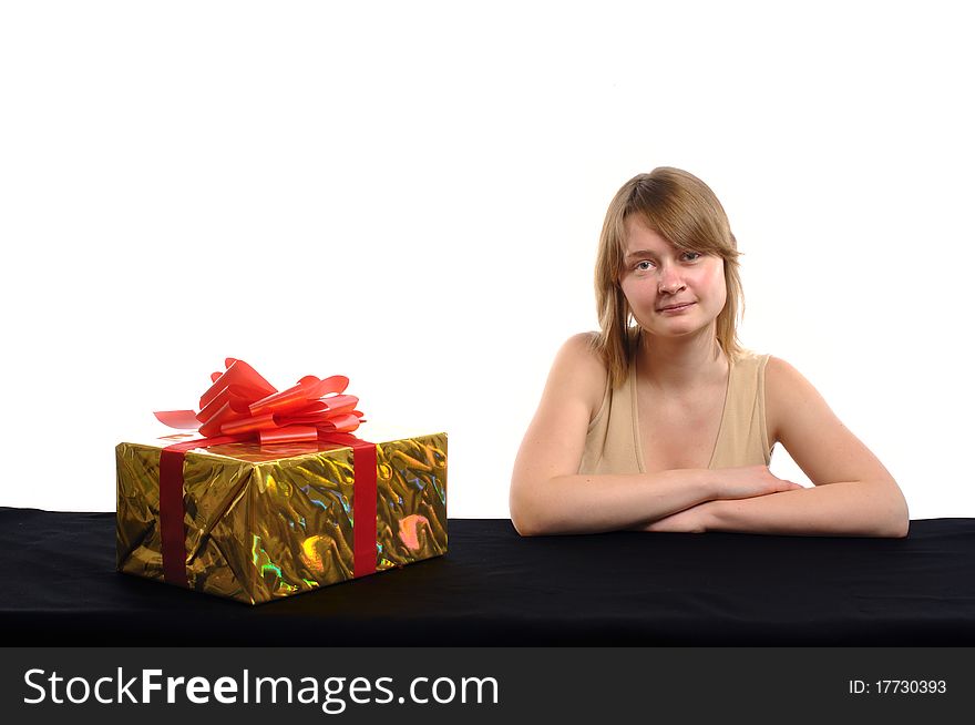 A young rather serious woman with a gift on a white background. A young rather serious woman with a gift on a white background