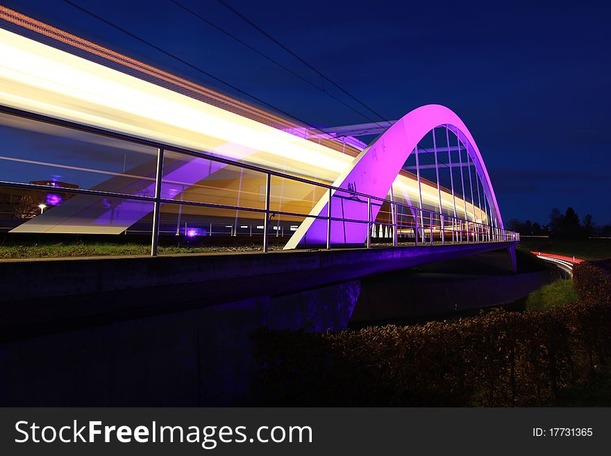 The bridge for light rails in Ostfildern near Stuttgart in Germany is illuminated at night. The bridge for light rails in Ostfildern near Stuttgart in Germany is illuminated at night