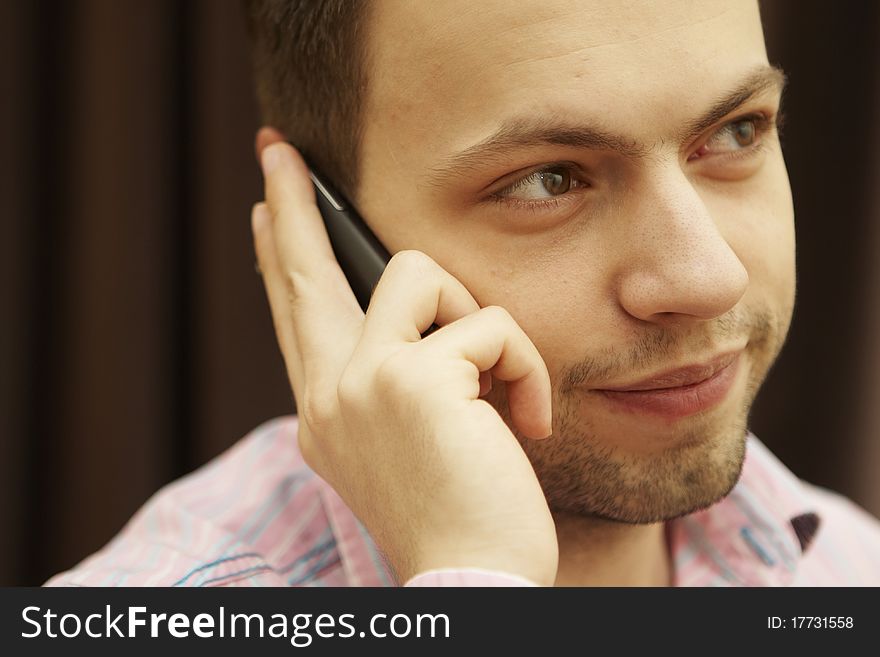 Young man with mobile phone in hand.