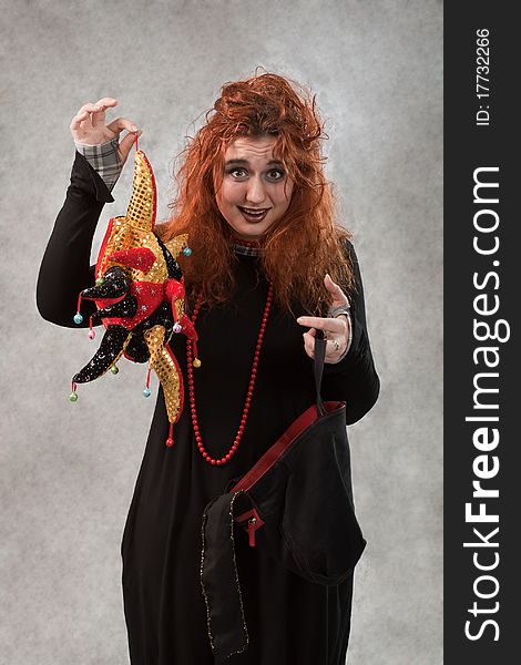 Crazy young woman with tousled hair and other items in the hands of