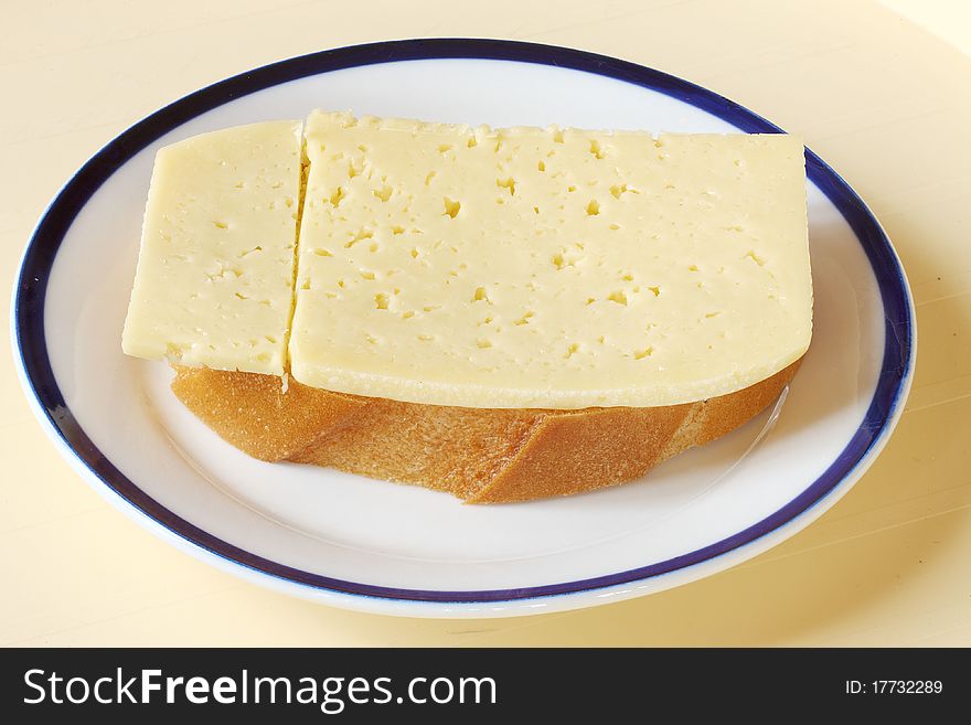 Bread and cheese on a ceramic plate. Bread and cheese on a ceramic plate.