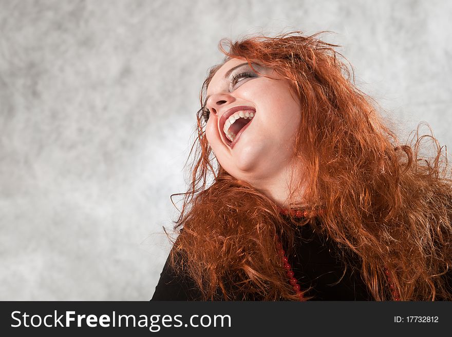 Crazy young woman with matted hair, his head thrown back laughing. Crazy young woman with matted hair, his head thrown back laughing