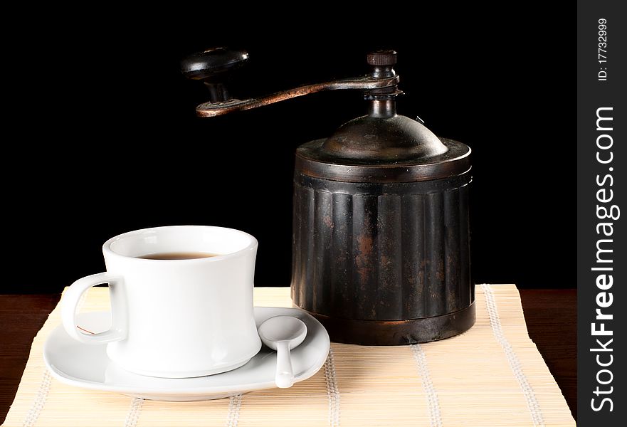 A cuo of coffee with vintage grinder. Studio shot. A cuo of coffee with vintage grinder. Studio shot.