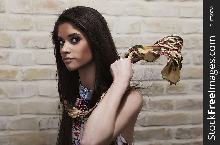 Young Sexy Woman On Brick Wall Background.