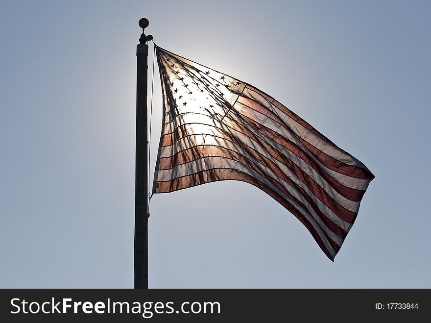 Morning sun shining through the American flag. Morning sun shining through the American flag