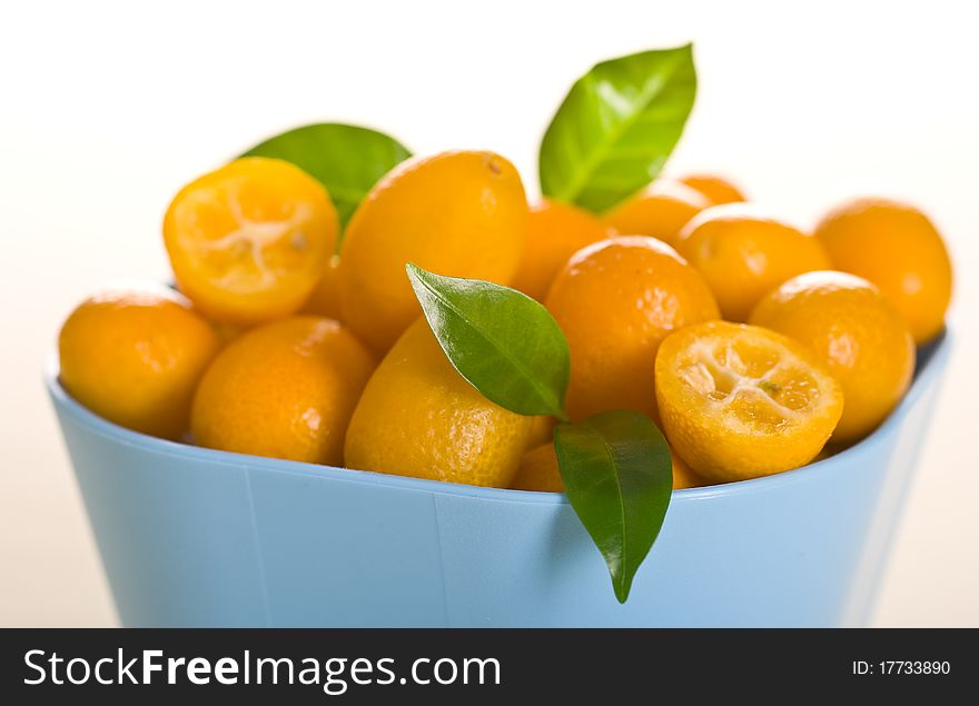 Kumquat small orange fruits on white background