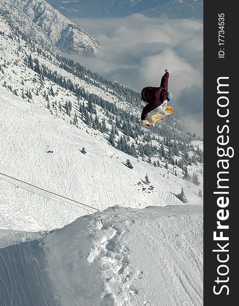 Jumping freestyle snowboarder