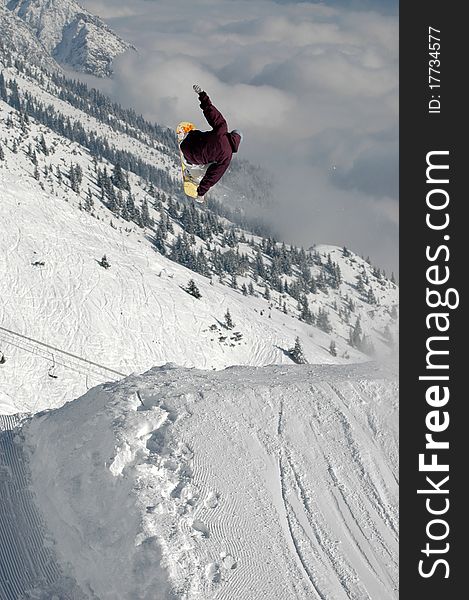 Jumping freestyle snowboarder