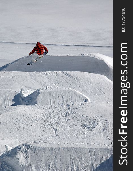 Jumping freestyle snowboarder