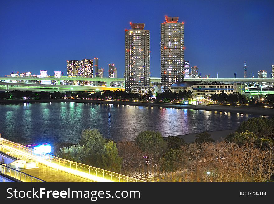 Two high rise buildings in Tokyo is shot from Odaiba Island, beautiful reflection can be seen on the water of the Tokyo Bay. Two high rise buildings in Tokyo is shot from Odaiba Island, beautiful reflection can be seen on the water of the Tokyo Bay