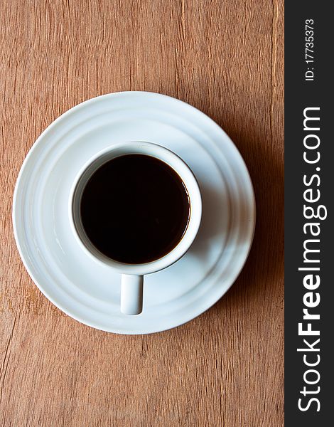 A cup of coffee on wood background