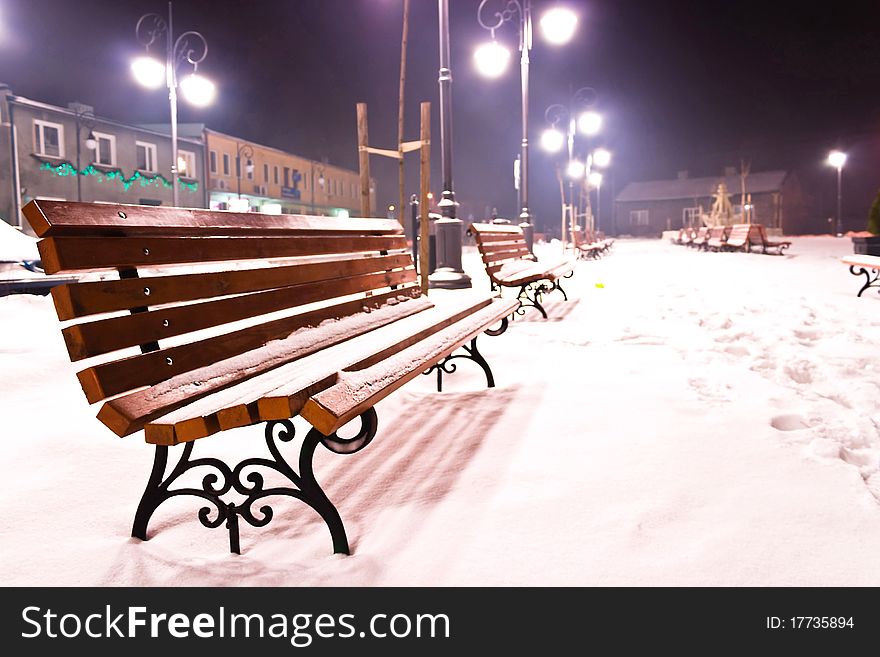 Bench in day alley with lights in Odessa, Ukraine. Photo in retro style.