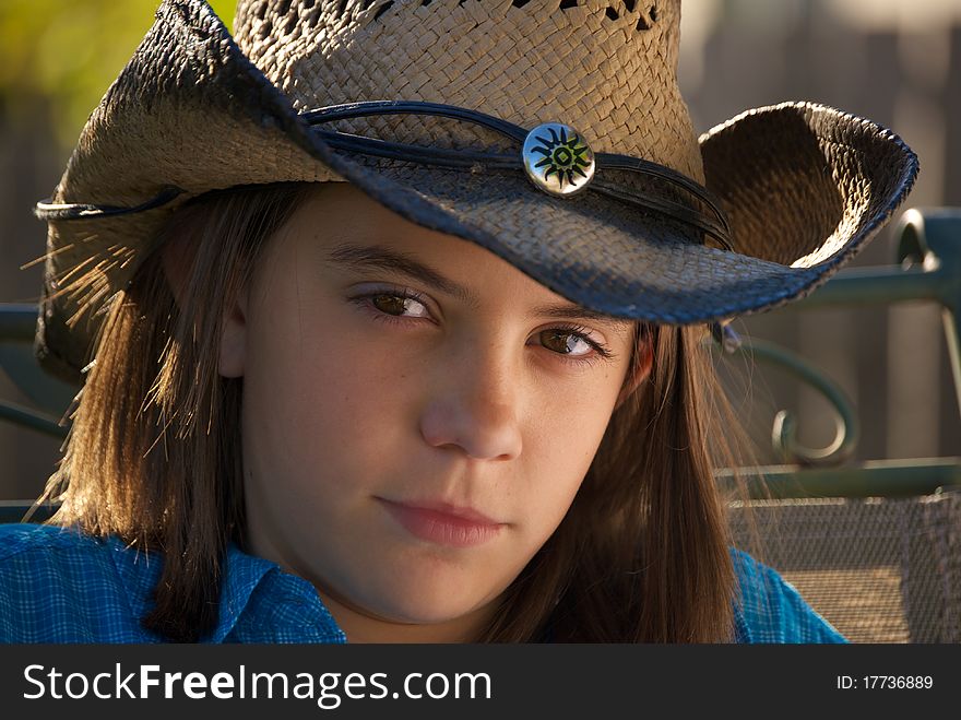 Head shot of young girl with brown eyes in cowboy hat and western wear. Head shot of young girl with brown eyes in cowboy hat and western wear