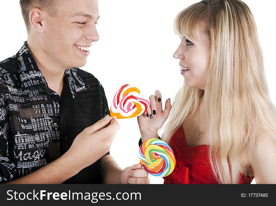 The young man treats the girl with a lollipop