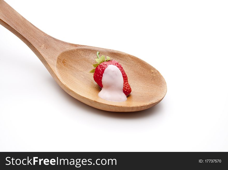 Strawberry yogurt on the wooden spoon