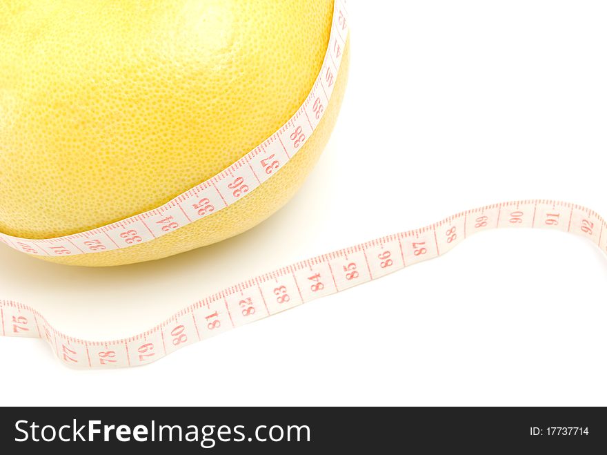 Grapefruit in the measuring tape, is isolated on a white background. Grapefruit in the measuring tape, is isolated on a white background