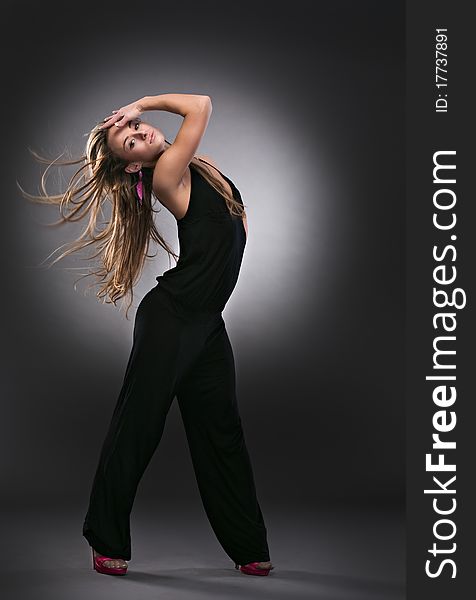 Cool dancer woman on gray background