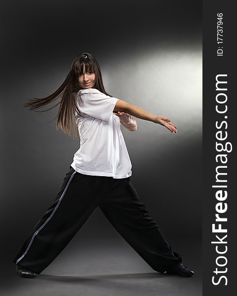 Cool dancer woman on gray background