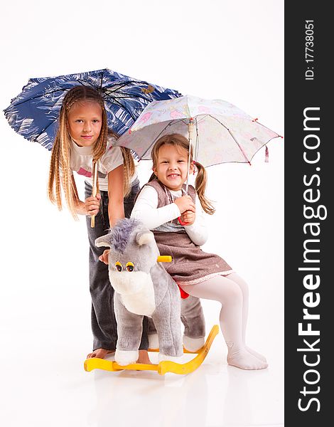 Two girls with umbrellas on a white background