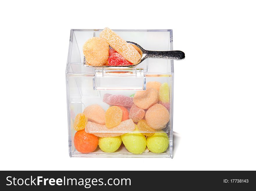 Multi-colored sweets and chewing gums in a transparent box