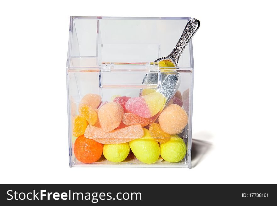 Multi-colored sweets and chewing gums in a transparent box