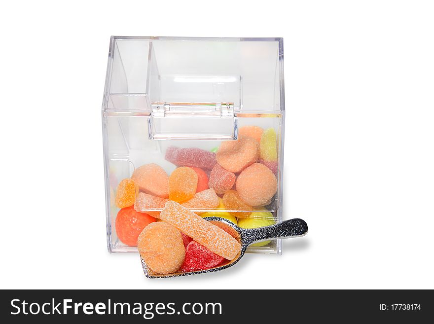 Multi-colored sweets and chewing gums in a transparent box
