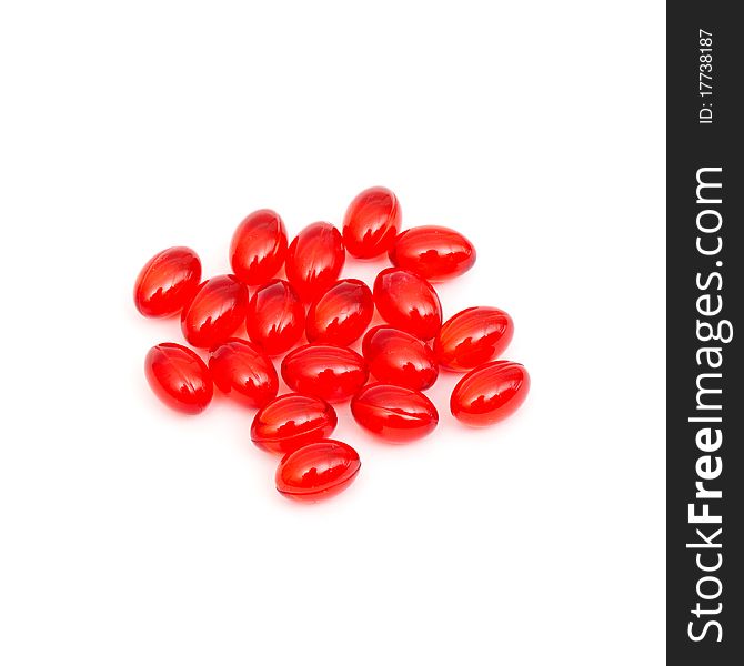 Red pills spilled isolated on white background. Red pills spilled isolated on white background