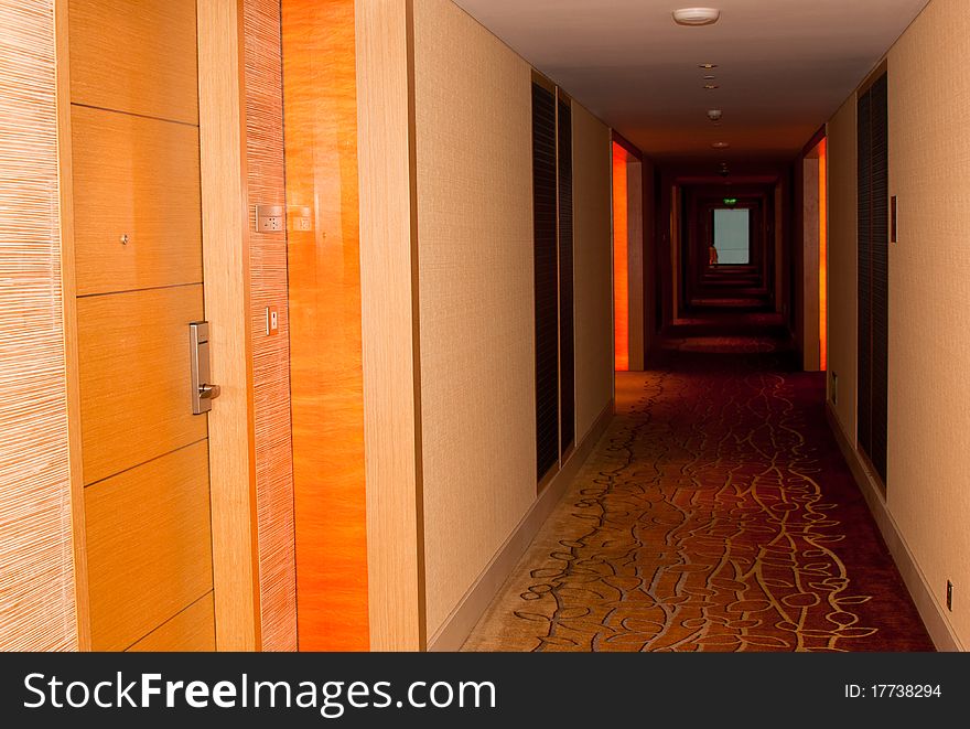 A perspective deep view of a hotel dark hallway. A perspective deep view of a hotel dark hallway