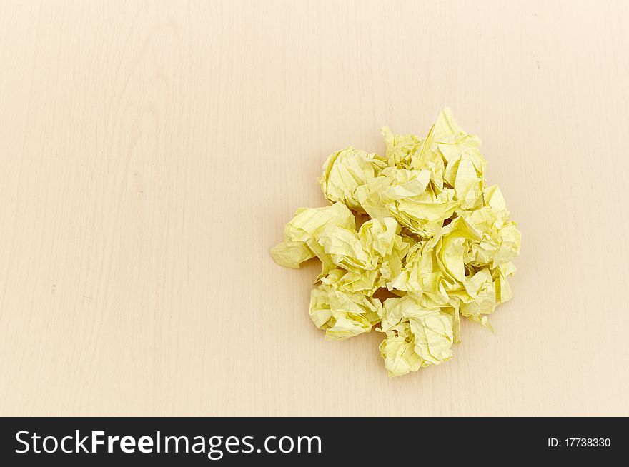 Yellow crumpled paper on wooden table background. Yellow crumpled paper on wooden table background