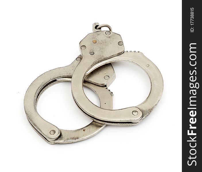 Steel metallic handcuffs (manacles) isolated on white background