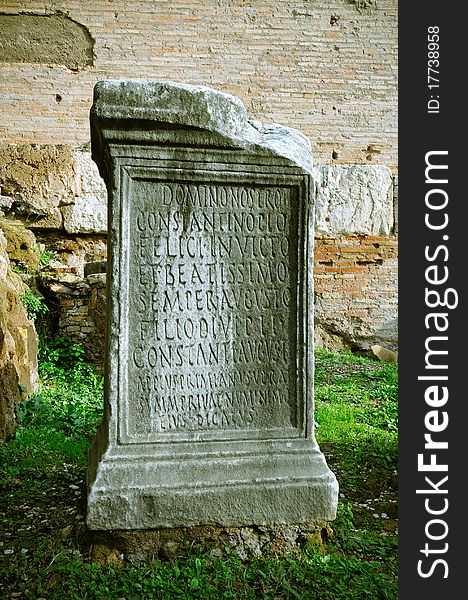 Pillar of stone with ancient Roman writings in Roman Forum, Rome, Italy.