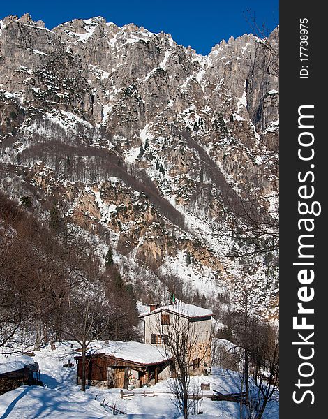 A beautiful landscape with snow covered mountains in a cold winter day. A beautiful landscape with snow covered mountains in a cold winter day